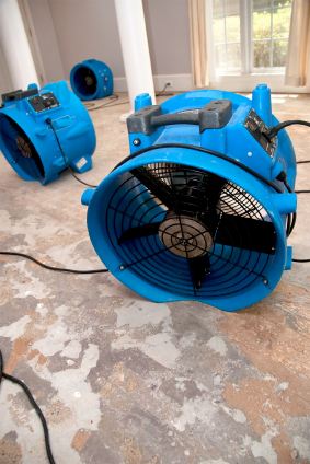 Commercial fans drying a water damaged living room in a Mid City West, PA home.