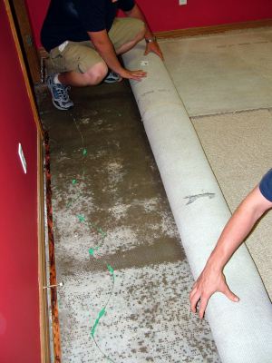 S&R Plumbing removing water damaged carpet before mold can grow.